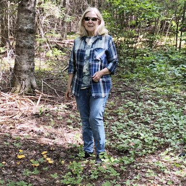 Ms Judy standing in the forest
