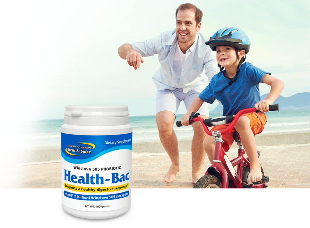 Learning to ride a bike on the beach with Health-Bac product bottle
