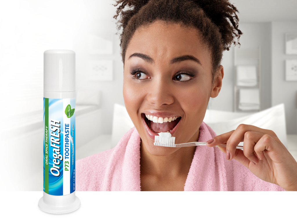 Woman brushing her teeth with OregaFresh toothpaste